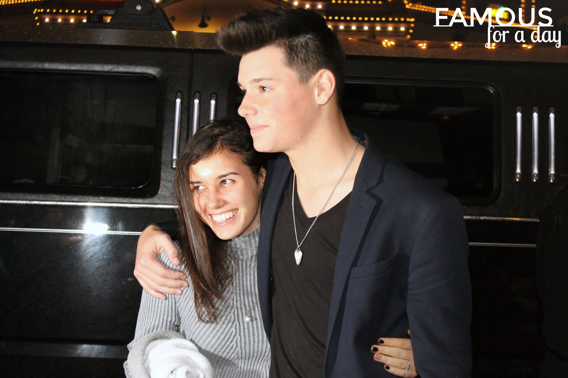 Couple arriving at a nighttime venue and receiving paparazzi-style attention